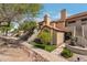 Inviting exterior featuring private entrances, desert landscaping, and charming details on a well-maintained building at 7675 E Mcdonald Dr # 107, Scottsdale, AZ 85250