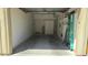 Clean and spacious garage interior with storage shelves, a door and cabinets for organization at 7675 E Mcdonald Dr # 107, Scottsdale, AZ 85250