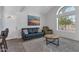 Cozy living room features vaulted ceilings, tile floors, a large window and stylish desert-themed art at 7675 E Mcdonald Dr # 107, Scottsdale, AZ 85250