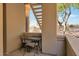 Private outdoor patio with seating and partial desert view, perfect for relaxing and enjoying the surroundings at 7675 E Mcdonald Dr # 107, Scottsdale, AZ 85250