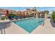 Community pool surrounded by lounge chairs and umbrellas, creating a resort-style atmosphere for relaxation and recreation at 7675 E Mcdonald Dr # 107, Scottsdale, AZ 85250