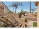Outdoor staircase offers access to upper units and desert views with cacti, rocks, and mountain backdrop at 7675 E Mcdonald Dr # 107, Scottsdale, AZ 85250