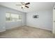 Bedroom featuring a ceiling fan, neutral walls, and large window for ample natural light at 7827 E Parkview Dr, Mesa, AZ 85208
