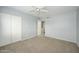 This cozy bedroom features carpet, ceiling fan, and closet for storage at 7827 E Parkview Dr, Mesa, AZ 85208