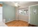 Inviting entryway featuring hardwood floors, a bright window, and a charming green door at 7827 E Parkview Dr, Mesa, AZ 85208