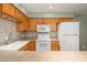 Close-up of kitchen area featuring wooden cabinets, white appliances, and ample counter space at 7827 E Parkview Dr, Mesa, AZ 85208