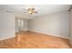 Spacious living room with hardwood floors, ceiling fan, neutral paint, and plenty of natural light at 7827 E Parkview Dr, Mesa, AZ 85208