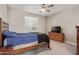 This cozy bedroom features a ceiling fan and natural light from the window, creating a relaxing ambiance at 8026 S 6Th Dr, Phoenix, AZ 85041
