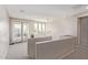 This hallway features neutral walls and carpeting, with a view to the outside from glass doors and picture windows at 8026 S 6Th Dr, Phoenix, AZ 85041