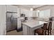 Modern kitchen featuring white cabinetry, stainless steel appliances, and a center island with seating at 8026 S 6Th Dr, Phoenix, AZ 85041
