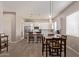 Spacious open-concept kitchen with white cabinets, stainless steel appliances, and an adjacent dining area at 8026 S 6Th Dr, Phoenix, AZ 85041