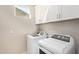 Convenient laundry room with modern appliances and white cabinets for storage at 8026 S 6Th Dr, Phoenix, AZ 85041