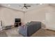 Comfortable living room with a ceiling fan, a modern television set, and neutral wall color at 8026 S 6Th Dr, Phoenix, AZ 85041