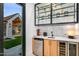 Bar area featuring custom cabinets, beverage center, and view of outdoor patio at 8220 E Sharon Dr, Scottsdale, AZ 85260