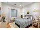 Well-lit bedroom featuring a pendant light, hardwood floors, and window with blinds at 8220 E Sharon Dr, Scottsdale, AZ 85260