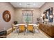 Elegant dining room with modern chandelier, neutral paint, and hardwood floors at 8220 E Sharon Dr, Scottsdale, AZ 85260