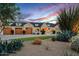 Charming home with a well-manicured front yard, lush landscaping, and a three-car garage at 8220 E Sharon Dr, Scottsdale, AZ 85260