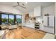 Open kitchen with modern appliances, large windows and a view of the outdoor pool area at 8220 E Sharon Dr, Scottsdale, AZ 85260