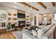 Comfortable living room with hardwood floors, and a modern fireplace with built-in shelving at 8220 E Sharon Dr, Scottsdale, AZ 85260