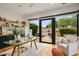 Modern home office with glass desk, built-in shelves, and sliding glass doors to the yard at 8220 E Sharon Dr, Scottsdale, AZ 85260