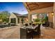 Inviting outdoor space featuring a covered dining area, outdoor kitchen, pool, and lounge seating at 8220 E Sharon Dr, Scottsdale, AZ 85260