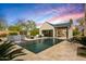 Stunning backyard pool with waterfall feature, outdoor kitchen, and covered patio for entertaining at 8220 E Sharon Dr, Scottsdale, AZ 85260