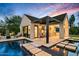 Luxury backyard pool area features a built in kitchen, lounge chairs, and covered seating at 8220 E Sharon Dr, Scottsdale, AZ 85260