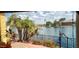 Outdoor patio area overlooking calm lake waters with palm trees at 8935 W Acoma Dr, Peoria, AZ 85381