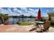 Inviting backyard with stone patio, outdoor seating, artificial turf and lake views at 8935 W Acoma Dr, Peoria, AZ 85381