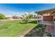 Covered patio with a manicured lawn, landscaping, and community views at 9816 N 95Th Dr # A, Peoria, AZ 85345