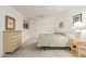 This bedroom features white walls, carpet and matching wooden dressers at 9816 N 95Th Dr # A, Peoria, AZ 85345