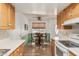 Open dining area featuring hardwood floors, wainscotting and views to the kitchen at 9816 N 95Th Dr # A, Peoria, AZ 85345