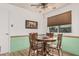 Bright dining area featuring wainscotting, hardwood floors, and natural lighting at 9816 N 95Th Dr # A, Peoria, AZ 85345