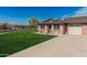 Well-maintained single-story home with a lush green lawn, brick exterior, and convenient attached garage at 9816 N 95Th Dr # A, Peoria, AZ 85345