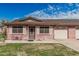 Charming brick home with a well-maintained lawn, covered entry, and attached one car garage at 9816 N 95Th Dr # A, Peoria, AZ 85345