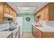Well-lit kitchen featuring white appliances, wood cabinets, and neutral countertops at 9816 N 95Th Dr # A, Peoria, AZ 85345