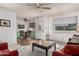 Cozy living room with open view of dining area, neutral palette, and natural light at 9816 N 95Th Dr # A, Peoria, AZ 85345