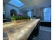 Modern bathroom with a double vanity, illuminated countertop, sleek cabinets, skylight and luxurious finishes at 10113 E Topaz Dr, Scottsdale, AZ 85258
