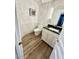 Stylish bathroom featuring marble walls, wood-look flooring, and vanity with a black countertop at 10113 E Topaz Dr, Scottsdale, AZ 85258