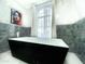 Modern bathroom featuring a sleek soaking tub, elegant marble, and contemporary fixtures, creating a spa-like experience at 10113 E Topaz Dr, Scottsdale, AZ 85258