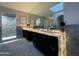 Modern bathroom showcasing a double vanity with illuminated countertop, sleek cabinets, shower, and skylight at 10113 E Topaz Dr, Scottsdale, AZ 85258