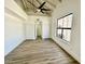 Spacious bedroom with vaulted ceilings, exposed beams, large window, and wood flooring at 10113 E Topaz Dr, Scottsdale, AZ 85258