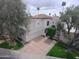 Stunning two-story home with a tile roof, lush landscaping, and a three-car garage at 10113 E Topaz Dr, Scottsdale, AZ 85258