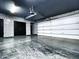 Sleek garage with a finished floor and stylish accent wall at 10113 E Topaz Dr, Scottsdale, AZ 85258