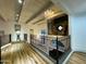 Hallway with hardwood floors, ornate wrought iron railing, and a modern light fixture at 10113 E Topaz Dr, Scottsdale, AZ 85258
