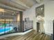 Bright landing with white wooden beams, black iron railing overlooking the pool, and decorative art at 10113 E Topaz Dr, Scottsdale, AZ 85258