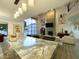 Open living space with a marble island and view to the modern seating area and fireplace at 10113 E Topaz Dr, Scottsdale, AZ 85258