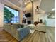 Bright living room with a fireplace, large windows, modern furnishings, and art pieces at 10113 E Topaz Dr, Scottsdale, AZ 85258