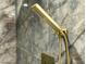 Close-up of a shower with a modern gold shower head and marble tile, creating a spa-like atmosphere at 10113 E Topaz Dr, Scottsdale, AZ 85258