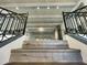 View of staircase featuring wood treads, custom iron railings, and beautiful beams in an elegant, bright interior at 10113 E Topaz Dr, Scottsdale, AZ 85258